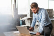 © Westend61 - Young businessman using laptop in a factory