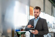 © Westend61 - Young businessman with tablet and workpiece in a factory