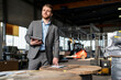 © Westend61 - Young businessman with tablet in a factory
