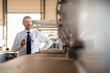 © Westend61 - Portrait of a confident mature businessman in a factory