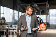 © Westend61 - Young businessman with tablet and workpiece in a factory