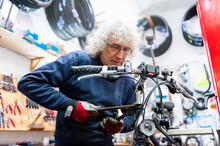 Bicycle Mechanic Working In Bike Shop