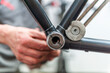 © Westend61 - Bicycle mechanic working at inner bearing of bike