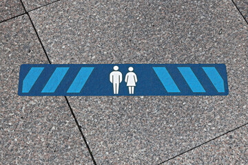 Blue marking on street in order to guide social distancing due to coronavirus or covid-19 pandemic. Blue marking indicating how much distance people should keep to be safe. 2.0 meters.