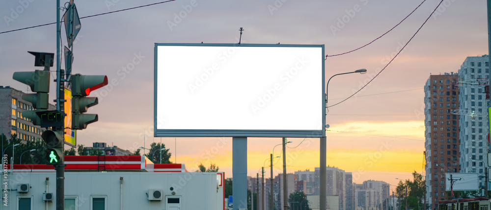 Advertising billboard advertising large horizontal screen MOCKUP for advertising. Against the background of the sunset, glowing. - obrazy, fototapety, plakaty 