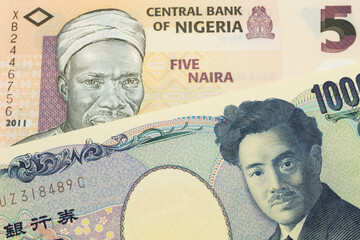 A macro image of a Japanese thousand yen note paired up with a orange, plastic five naira note from Nigeria.  Shot close up in macro.