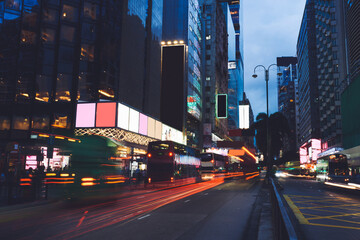 Publicity mock up area for advertising or commercial information Lightbox on exterior of modern buildings, blank illuminated billboards with copy space on skyscraper facade in city district at night