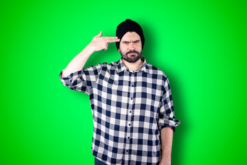 Wall Mural - Portrait of a puzzled bearded man holding hands on his head isolated over chroma background