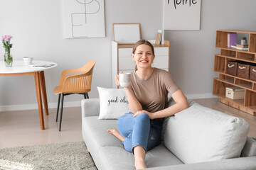 Woman relaxing on sofa before weekends at home