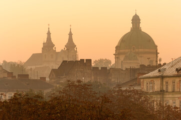 Wall Mural - Lviv city roofs and Dominican Cathedral silhouette at sunrise, Ukraine