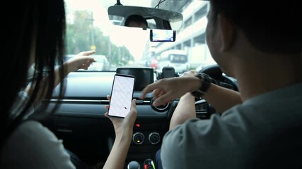 Wall Mural - Navigation concept. Couple asian using smartphone with map in car. 4k Resolution.