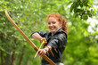 © Pixel-Shot - Sporty young woman practicing archery outdoors