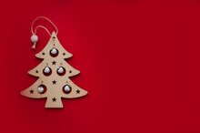 Christmas Composition. Christmas Wooden Decorations And Tinsel On A Red Background. Flat Layout, Top View, Space For Text.