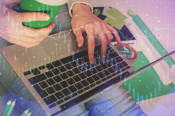 Double exposure of woman hands typing on computer and forex chart hologram drawing. Stock market invest concept.