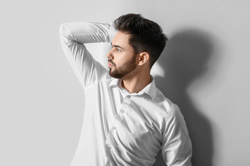 Wall Mural - Handsome man with stylish hairdo on white background