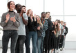 © ASDF - group of diverse young people applaud standing in a row