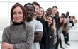 © ASDF - close-up . young woman standing in front of a group of young people