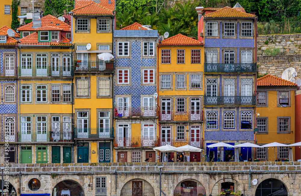 Traditional house facades decorated with Portuguese azulejo tiles in