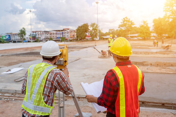 Wall Mural - Backside engineer team working the surveyor at the construction site