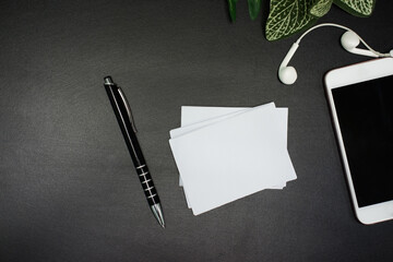 Blank pens and paper placed on a black background for business, education and others you design.