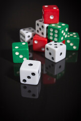 Multi-colored dice on a black surface