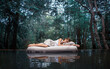  Sleeping woman in deep forest lies on airbed 