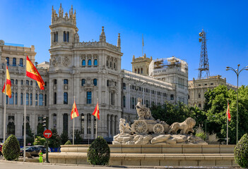 Wall Mural - Ornate gothic Cibeles Palace or Palacio de Comunicaciones building and Cibeles fountain with Spanish flags Madrid, Spain