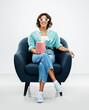 © Syda Productions - comfort, people and furniture concept - portrait of happy smiling young woman in 3d movie glasses with popcorn in striped bucket sitting in modern armchair over grey background