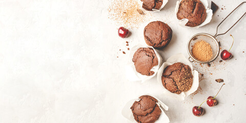 Homemade fresh chocolate muffins with berries and chocolate pieces. Top view.