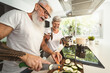 © Alessandro Biascioli - Happy senior couple having fun cooking together at home - Elderly people preparing health lunch in modern kitchen - Retired lifestyle family time and food nutrition concept