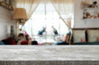 © qOppi - Empty wooden table space platform and blurred restaurant or coffee shop background for product display montage.