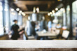 © qOppi - Empty wooden table space platform and blurred restaurant or coffee shop background for product display montage.