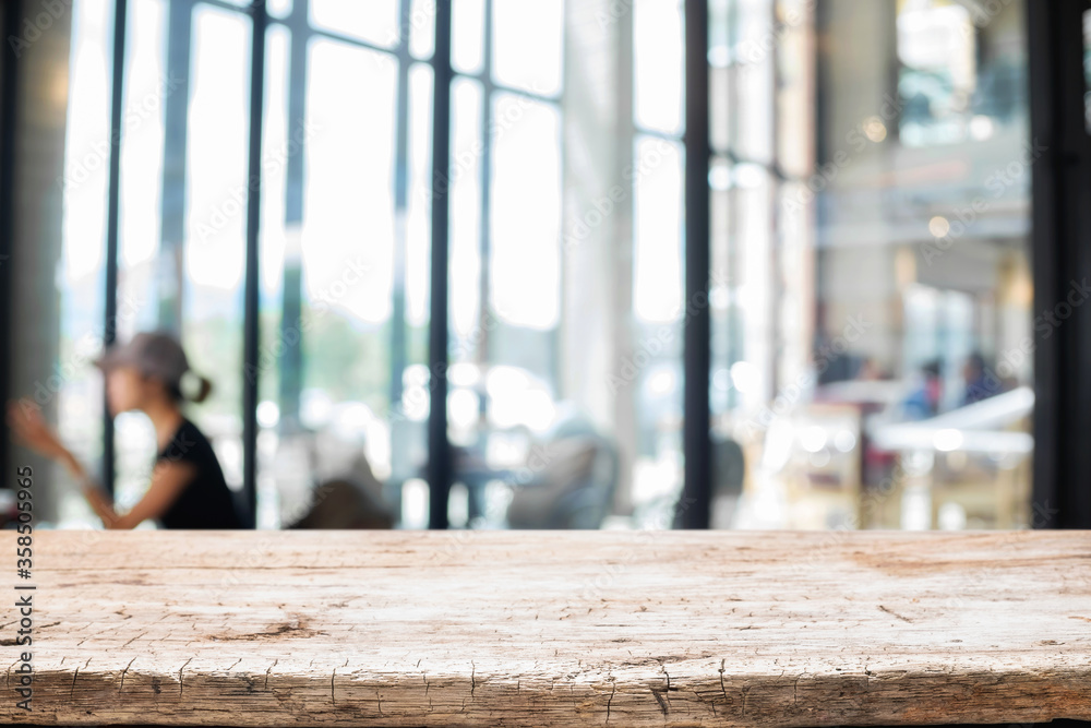 Empty wooden table space platform and blurred restaurant or coffee shop ...