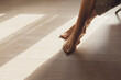 © stokkete - Female feet on hardwoord floor and sunlight