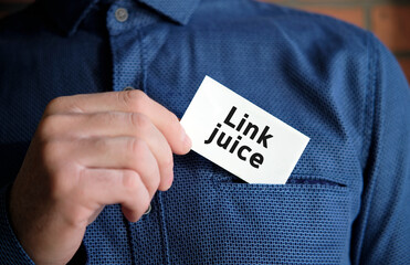 Link juice text on a white sign in the hand of a man in shirt