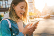 © Drobot Dean - Cheerful young blonde girl using mobile phone