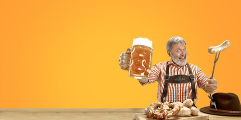 Wall Mural - Delighted senior man with beer dressed in traditional Austrian or Bavarian costume holding mug of beer at pub or studio. The celebration, oktoberfest, festival, drinking concept. Flyer with copyspace.