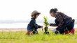 © freebird7977 - Asian  kid daughter helping mother water and sapling  the plant tree outdoors in nature spring