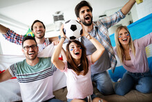 Young Group Of Friends Watching Sport On Television