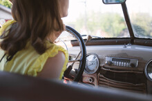Young Woman Driving An Old Car. Selective Focus.