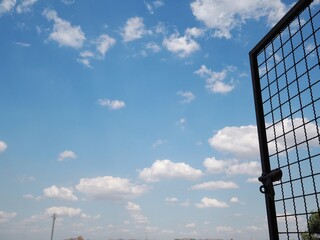 Opening old metal iron protection window with cloudy nice sky background freedom concept