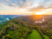 Aerial View Of Beautiful Sunset Over The Karlstejn Castle, Czech Republic. Drone Shot Of Ancient Castle With Near Forest. Castle In Gothic Style Was Build By Emperor Of Rome Rise, Charles IV.
