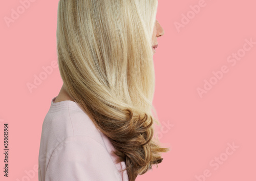 Senior woman with long blonde hair standing over pink background Poster Mural XXL