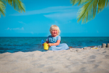 Sticker - cute little girl play with sand on beach