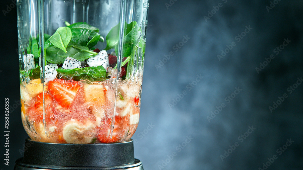Fresh fruit and vegetables smoothie blended in blender, back view. Healthy eating concept. - obrazy, fototapety, plakaty 