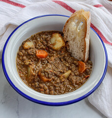 Wall Mural - Lentil soup with vegetables and potatoes. Typical Spanish lentil soup. 