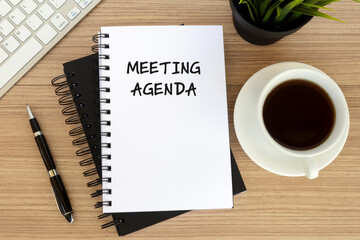 Wall Mural - Meeting agenda text on note pad with cup of coffee