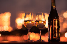 Pair Of Wine Glasses And A Beautiful Night City View. Fine Dinning Concept. 