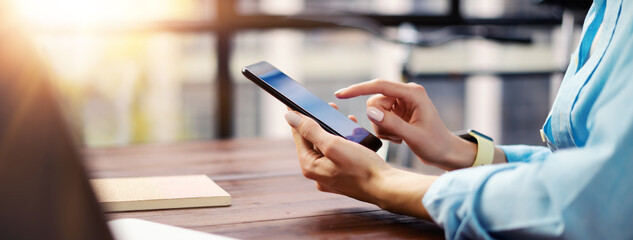 Woman pointing on smartphone screen, chatting in social networks, meeting website, searching internet, sending sms, using text messenger or online banking.