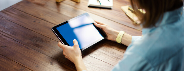 Woman pointing on digital tablet screen, chatting in social networks, meeting website, searching internet, sending sms, using text messenger or online banking. Close up photo